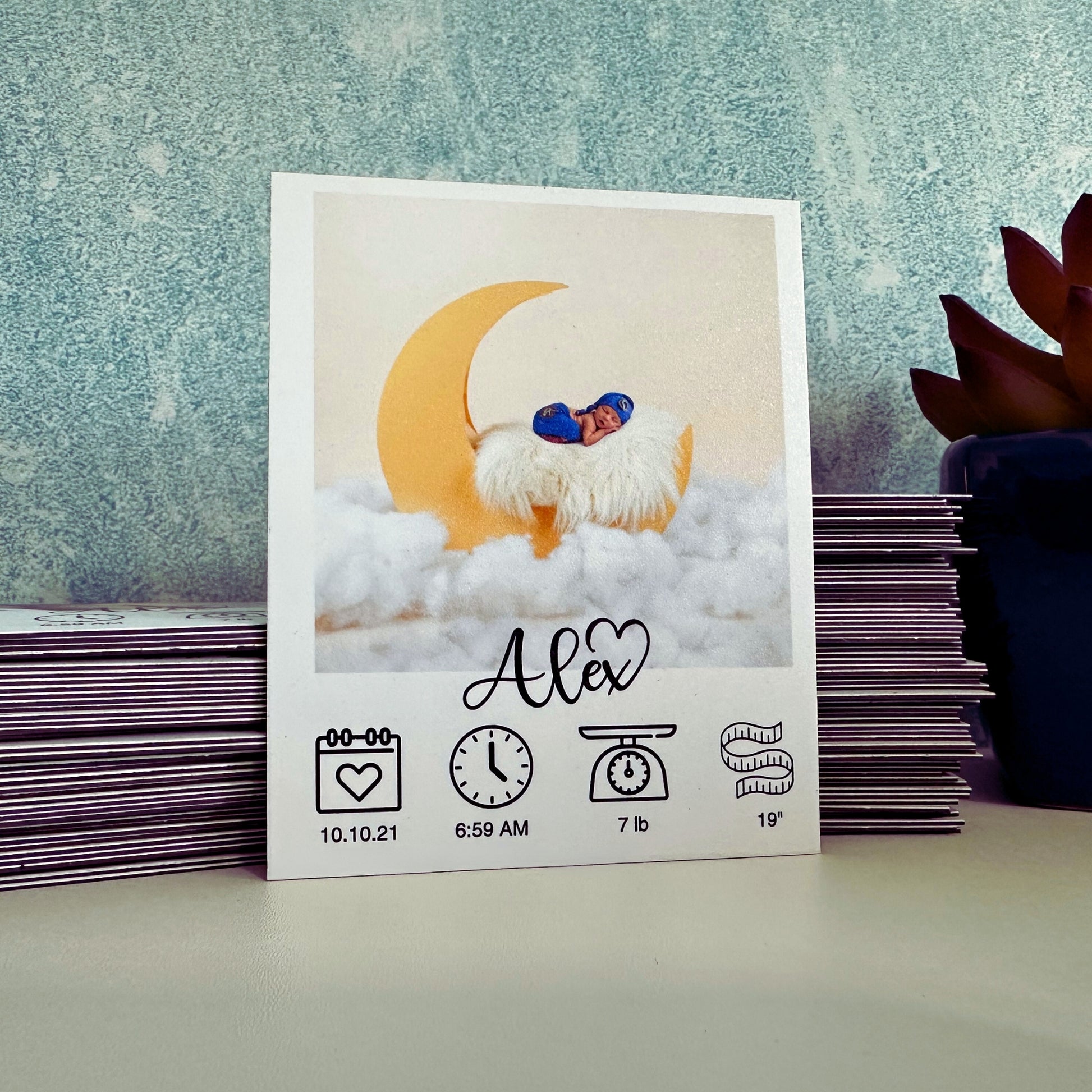 Baby milestone custom photo magnet with baby's photo, name, and birth details on a textured surface.
