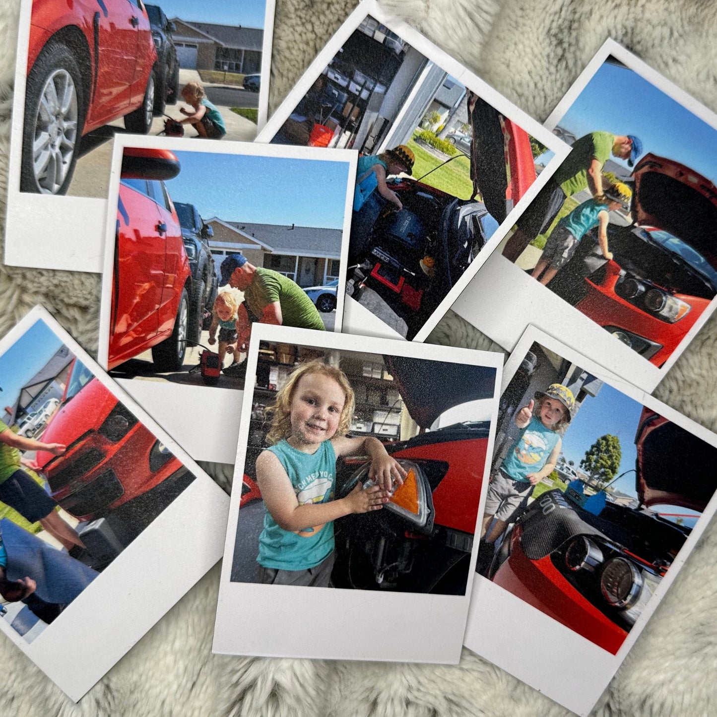 Collection of Polaroid photo magnets showing a child interacting with a red car on a white fluffy blanket.