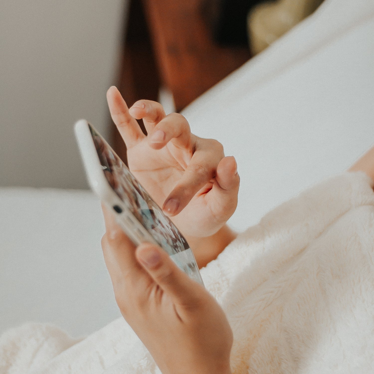 Person Holding a Smartphone and Selecting Photos to Upload for Making Custom Photo Magnets