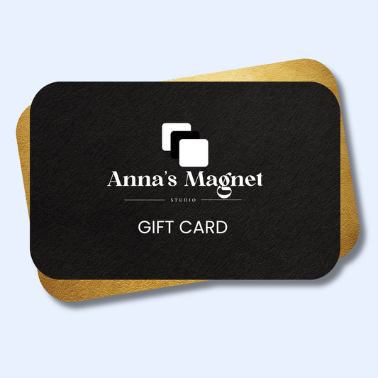 Black gift card with 'Anna's Magnet Studio' logo on a light blue background