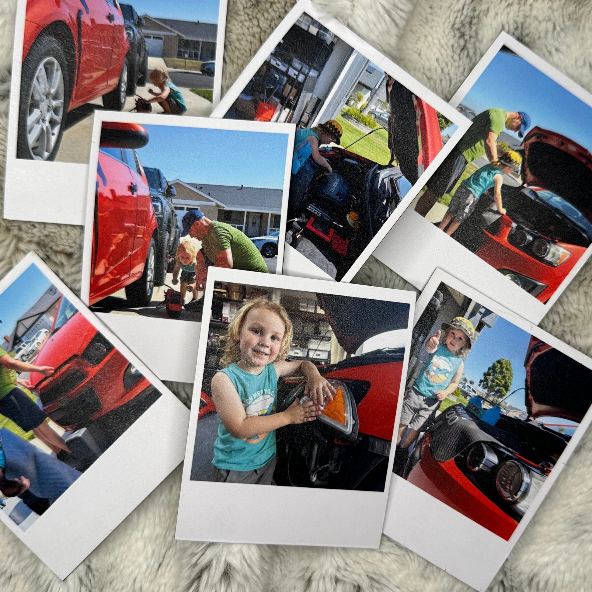 Collection of Polaroid photo magnets showing a child interacting with a red car on a white fluffy blanket.