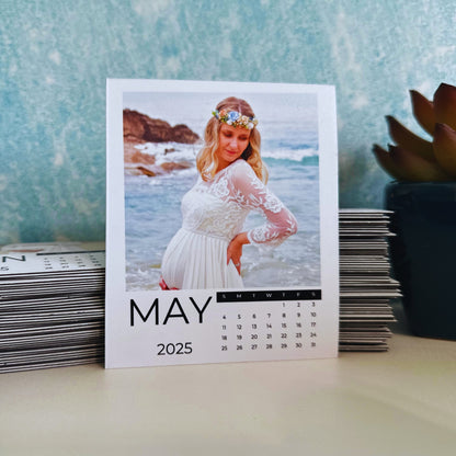 May 2025 calendar with a scenic design on a table