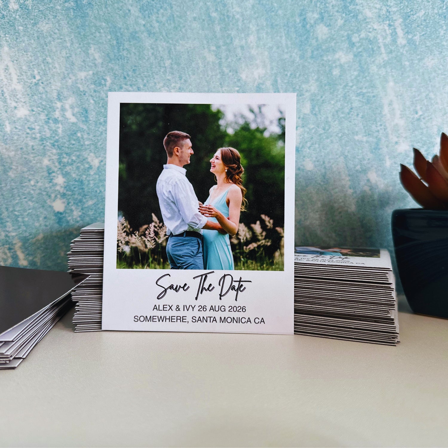 Wedding save the date magnet with a couple photo on a textured surface